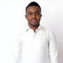 Portrait of young african businessman against white wall