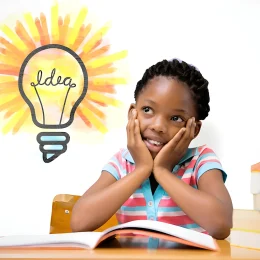 Pupil sitting at her desk against white background with vignette